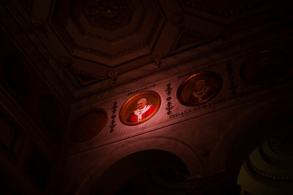 FILE - A light illuminates a polychrome mosaic portrait of Pope Francis placed on the frieze of St. Paul's Outside The Walls Basilica in Rome, Wednesday, Feb. 26, 2025. (AP Photo/Bernat Armangue, File)