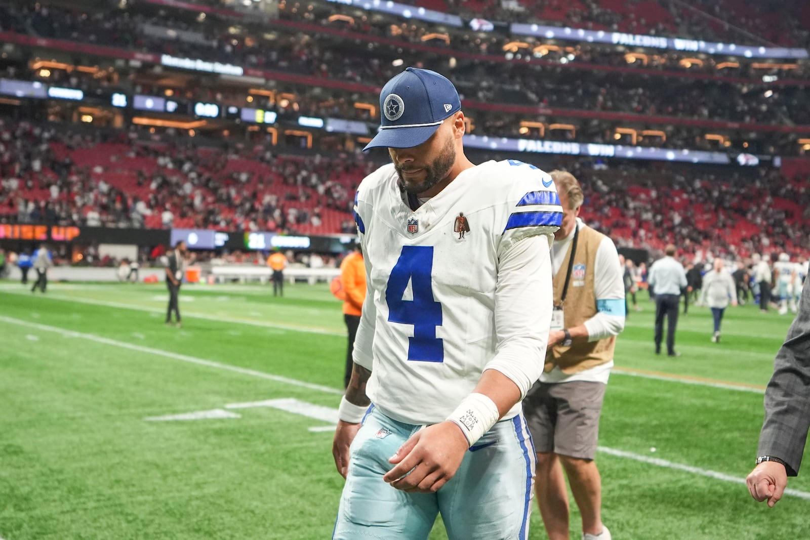 Dallas Cowboys quarterback Dak Prescott (4) walks off the field after an NFL football game against the Atlanta Falcons, Sunday, Nov. 3, 2024, in Atlanta. The Falcons won 27-21. (AP Photo/ Brynn Anderson)