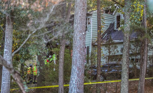 State investigators and a Sandy Springs police K-9 unit were on the scene of a house fire searching for victims the day after it went up in flames.

