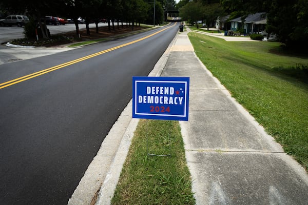 A “Defend Democracy 2024” sign sits in the grass of a neighborhood in Birmingham, Ala., on June 18, 2024. (Photo by Jordan Moore/News21)