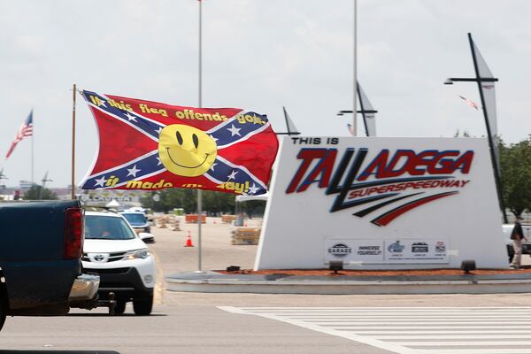 Race fans fly Confederate battle flags and United States flags as they drive outside the entrance to Talladega Superspeedway prior to a NASCAR Cup Series auto race in Talladega Ala., Sunday, June 21, 2020. (AP Photo/John Bazemore)