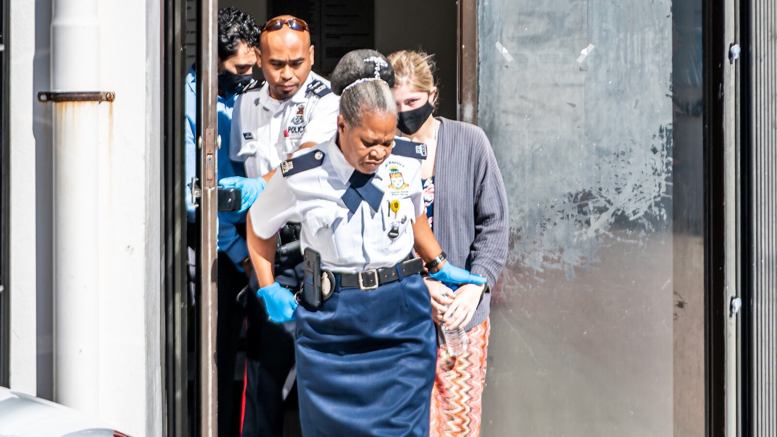 Vanjae Ramgeet and Skylar Mack are led out of the courthouse on their way to prison after being sentenced at George Town Court House. Skylar, who is a pre-med student at Mercer, and Ramgeet, a professional jet ski rider, were sent to jail for four months for breaching isolation rules. (Taneos Ramsay / Cayman Compass)