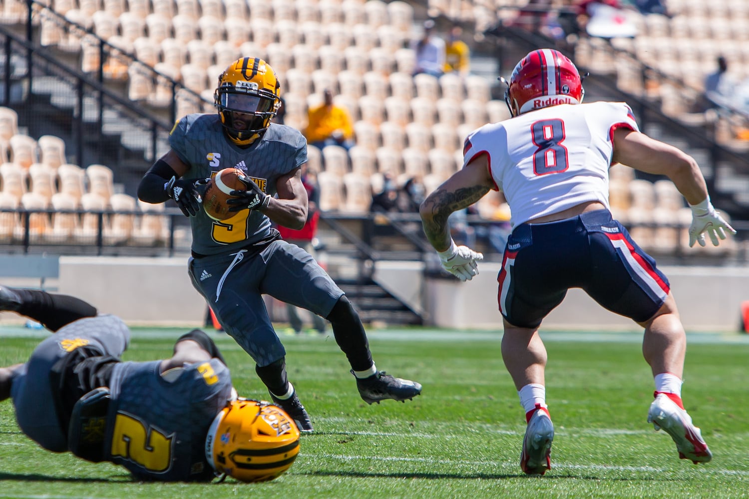 Tommy Bryant, quarterback for Kennesaw State, keeps the ball. CHRISTINA MATACOTTA FOR THE ATLANTA JOURNAL-CONSTITUTION.