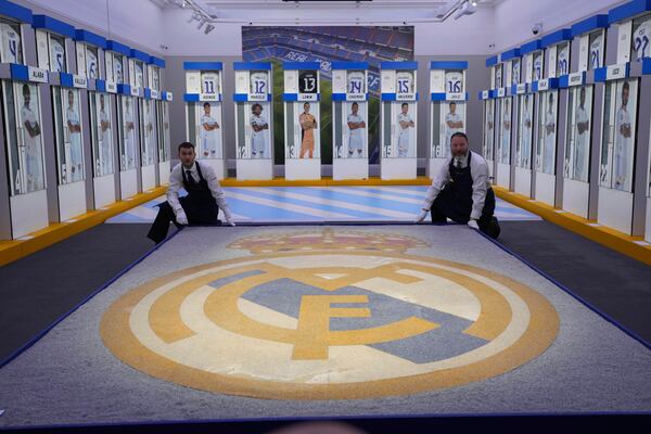 The Real Madrid first-team changing room lockers and stadium's mosaic from Santiago Bernabeu Stadium are displayed at Sotheby's auction rooms in London, Wednesday, Nov. 20, 2024. The sale features 24 individual lockers previously used by footballers including Cristiano Ronaldo, David Beckham and Zinedine Zidane. (AP Photo/Kin Cheung)