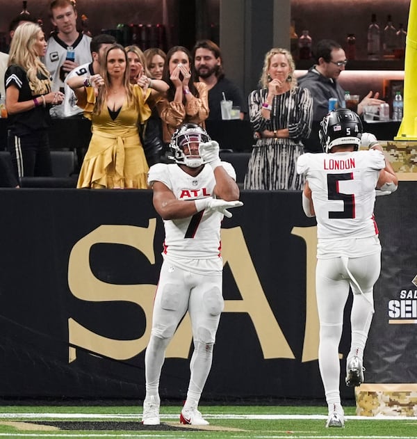 Atlanta Falcons running back Bijan Robinson (7) celebrates his touchdown reception with wide receiver Drake London (5) in the second half of an NFL football game against the New Orleans Saints in New Orleans, Sunday, Nov. 10, 2024. The Saints won 20-17. (AP Photo/Gerald Herbert)