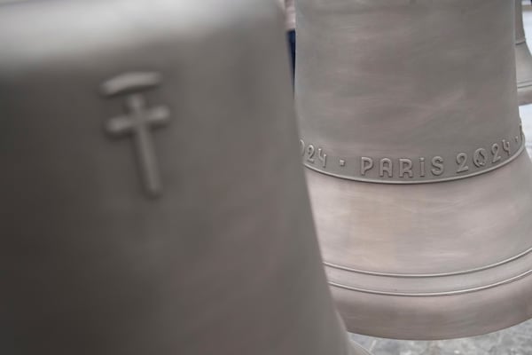 The bell that Olympic medalists rang at the Paris Games, right, is seen before its installation in Notre-Dame cathedral, ahead of the monument's grandiose reopening following a massive fire and five-year reconstruction effort, Thursday, Nov. 7, 2024 in Paris. (AP Photo/Christophe Ena)