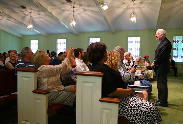 Carter shares a laugh with the congregation as he asks where they are from before beginning his Sunday School lesson at Maranatha Baptist Church on Sunday, June 15, 2014, in Plains. Visitors are allowed to snap photos during his greeting, but are asked to refrain during his lesson. (Curtis Compton, ccomption@ajc.com)