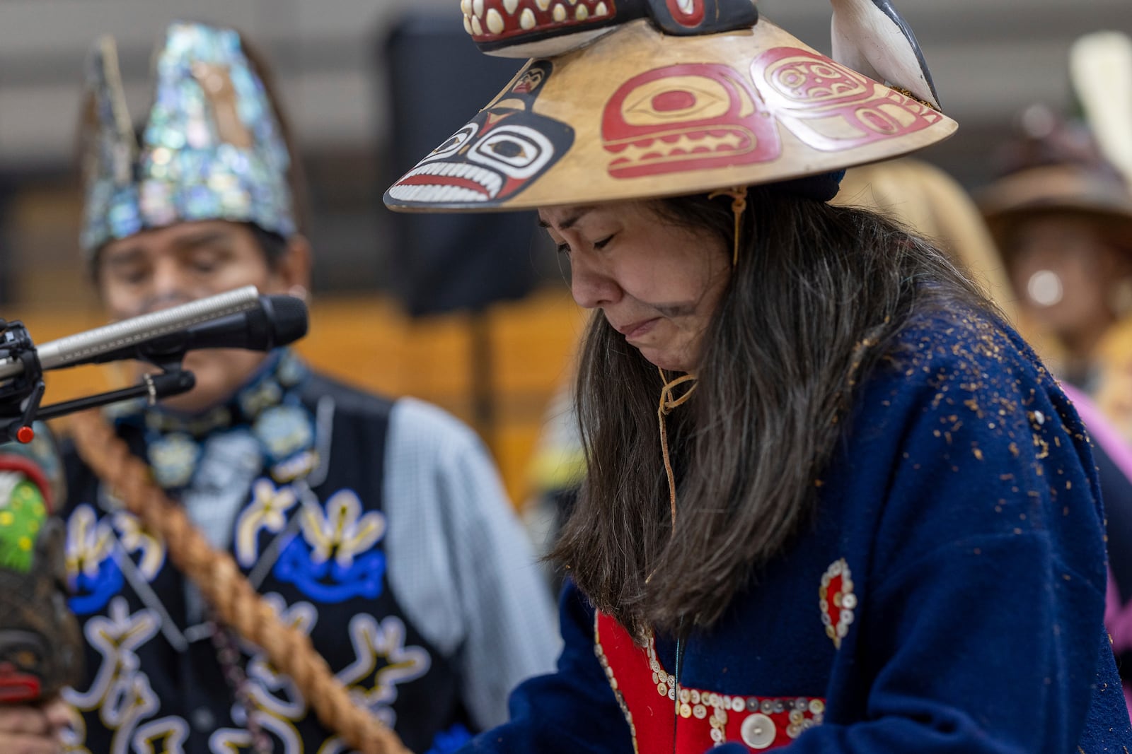 Angoon resident Shgen George tears up as she recounts the bombardment of Angoon from the Tlingit perspective during a Navy ceremony Saturday, Oct. 26, 2024, in Angoon, Alaska, to apologize for the 1882 military bombing. (Nobu Koch/Sealaska Heritage Institute via AP)