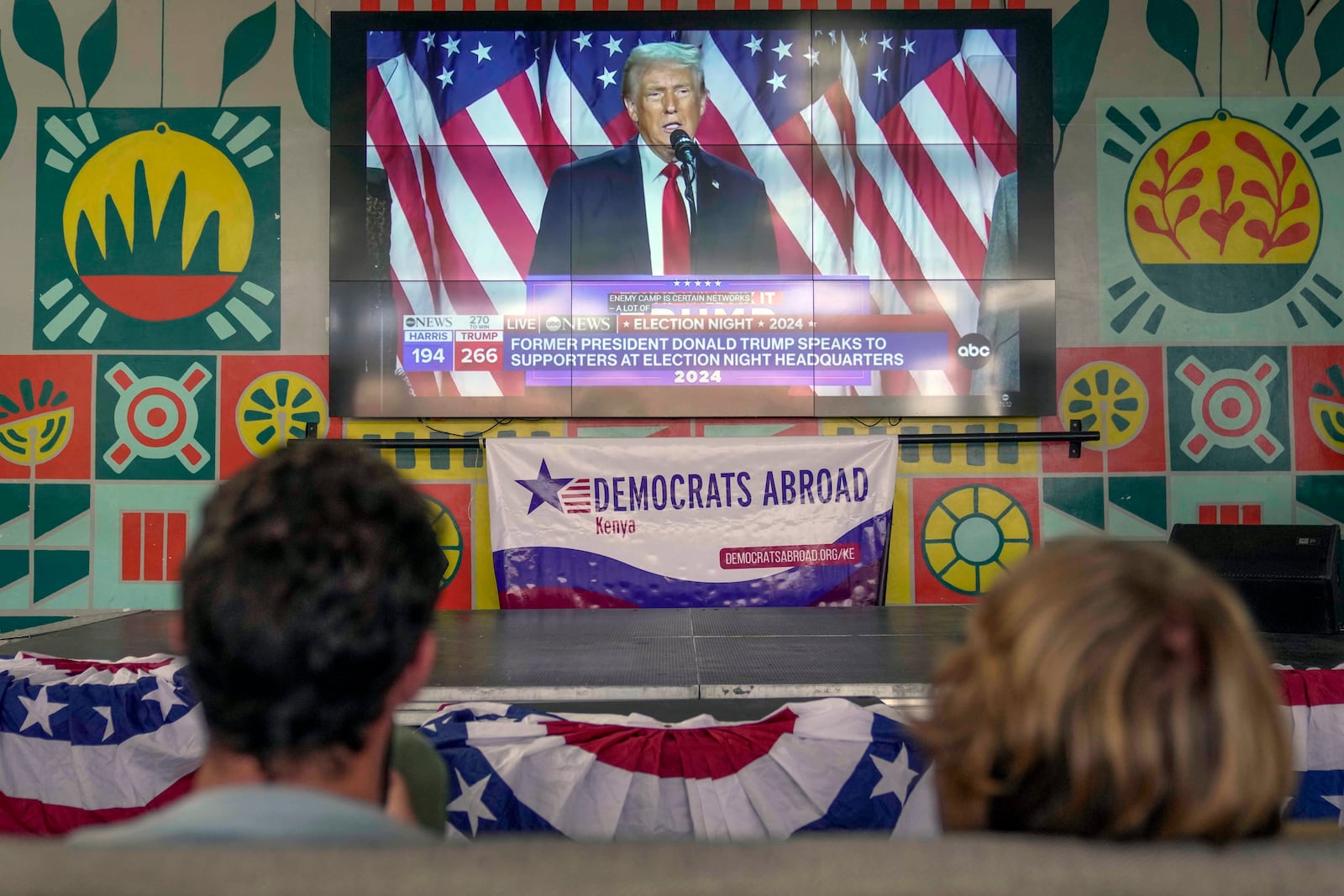 A screen shows live footage of Republican presidential nominee former President Donald Trump speech during a news program in Nairobi, Kenya, Wednesday, Nov. 6, 2024. (AP Photo/Brian Inganga)