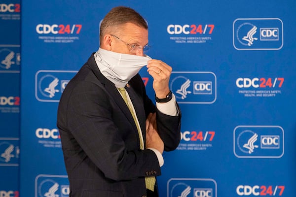 Georgia Congressman Doug Collins adjusts his face mask before the start of a round table discussion with Vice President Mike Pence and Dr. Robert Redfield, Director of the Centers for Disease Control and Prevention, at the Center for Disease Control and Prevention in Atlanta, Friday, Dec. 4, 2020.  (Alyssa Pointer/Atlanta Journal-Constitution/TNS)