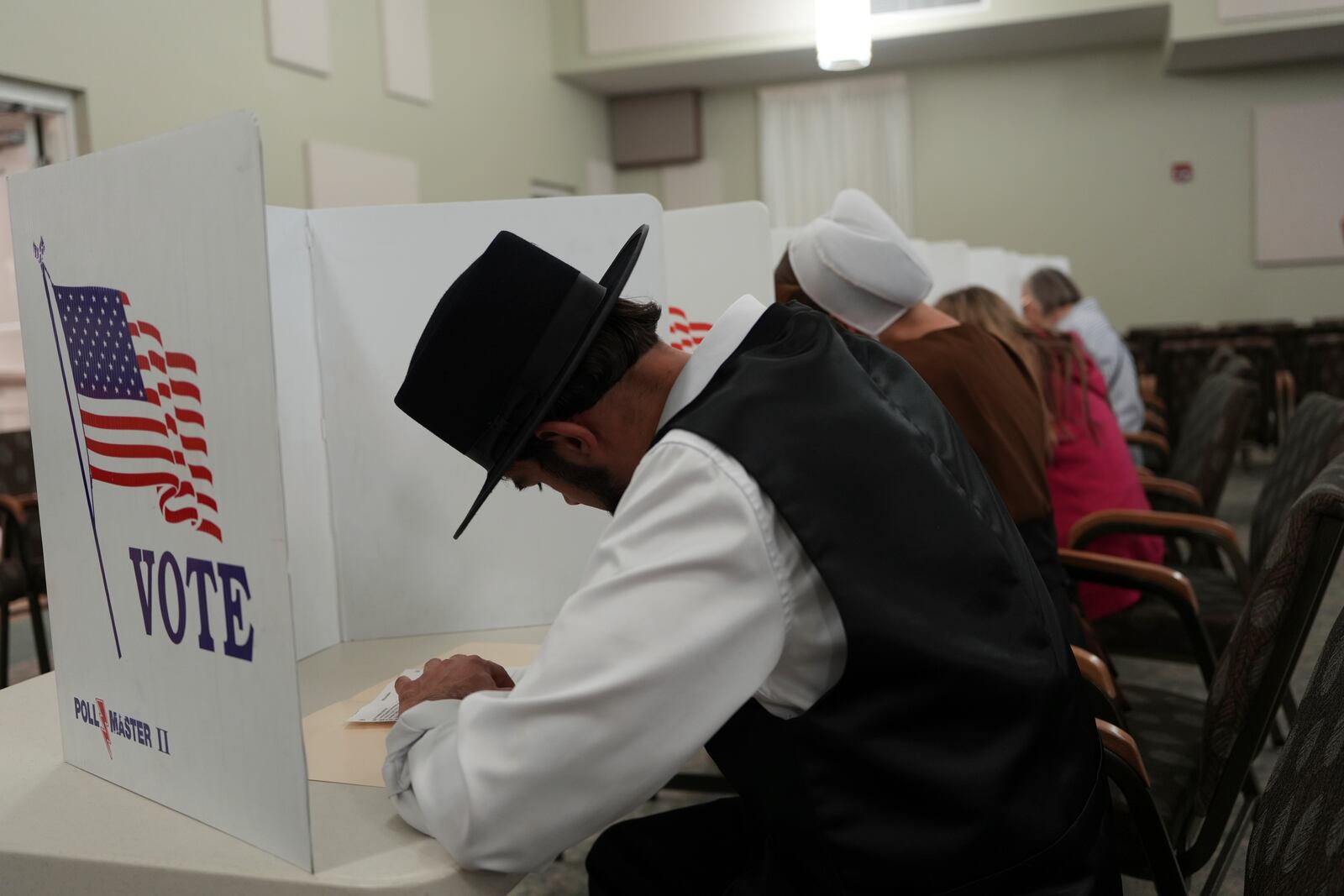 Members of the Amish community, Samuel Stoltzfus and his wife Lillian Stoltzfus, vote at a polling center at the Garden Spot Village retirement community in New Holland, Pa., Tuesday, Nov. 5, 2024. (AP Photo/Luis Andres Henao)