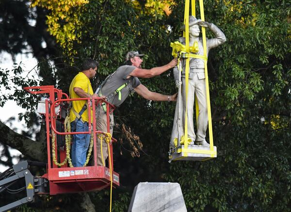 The Confederate statue located in the Circle at the University of Mississippi is lowered  as part of the process to move it to the Confederate Soldiers Cemetery on campus in Oxford, Mississippi.