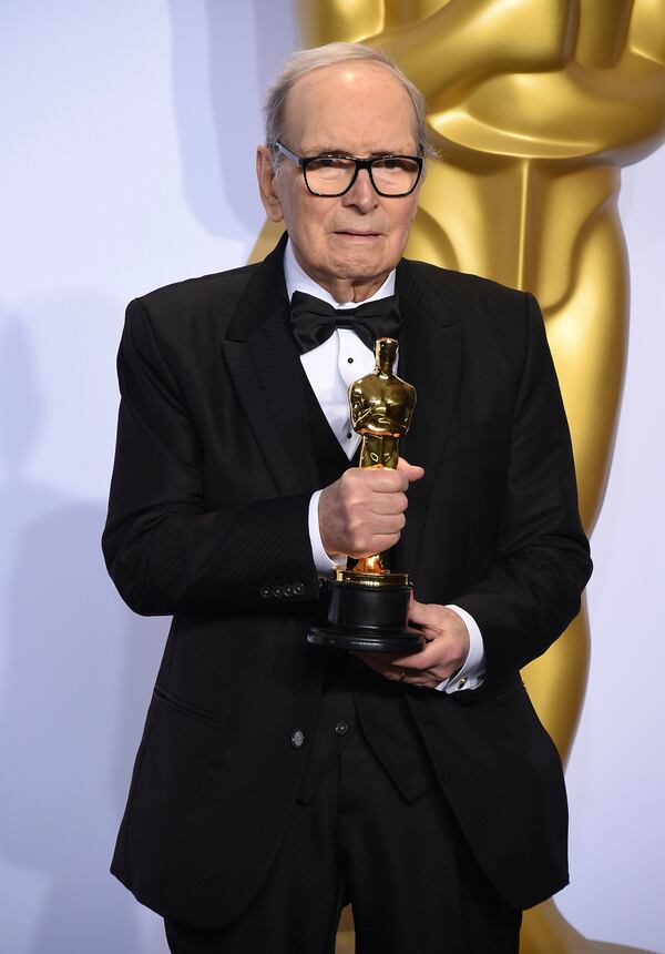  Italian composer Ennio Morricone poses with the award for best original score for "The Hateful Eight" at the Oscars.