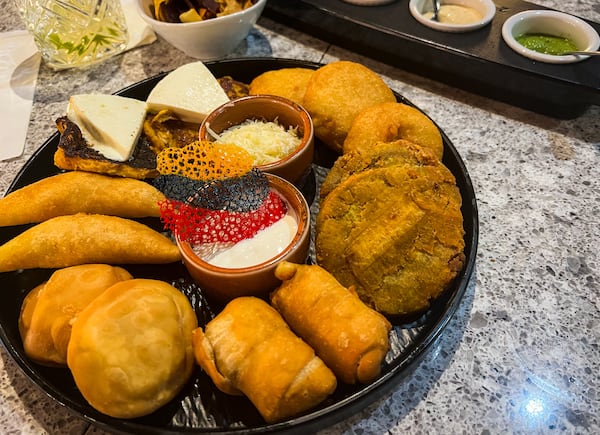 A Venezuelan tour offers miniature versions of some of the main offerings at Arepa Grill Kitchen & Wine. (Henri Hollis/henri.hollis@ajc.com)