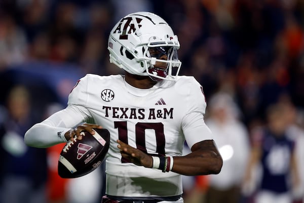 Texas A&M quarterback Marcel Reed throws a pass during the first half of an NCAA college football game against Auburn, Saturday, Nov. 23, 2024, in Auburn, Ala. (AP Photo/Butch Dill)