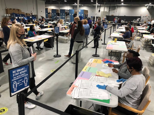 An recount observers monitors the count Saturday, Nov. 14, 2020, at the Gwinnett County elections building in Lawrenceville.