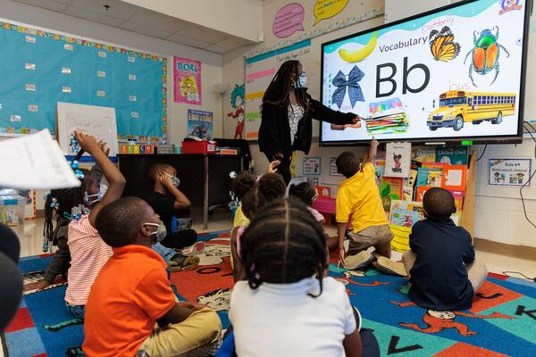 Kindergarten students participate in Kencheryl Smalls’ class at T.H. Slater Elementary School. The influx of new students at Slater from the Forest Cove Apartments has led to larger class sizes, new bus routes and a last-minute push to hire staff. (Arvin Temkar / arvin.temkar@ajc.com)