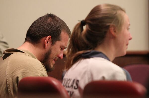 Jose Torres weeps in his seat at his sentencing at the Douglas County Courthouse on Monday. Next to him is his partner, Kayla Norton. (Henry Taylor / henry.taylor@ajc.com)