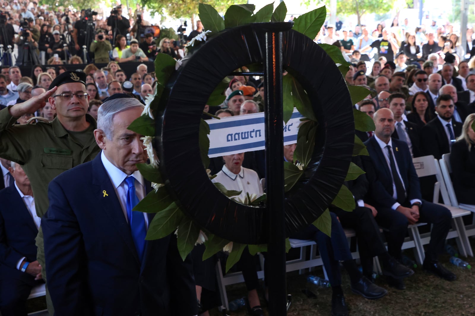 Israel's Prime Minister Benjamin Netanyahu takes part in a ceremony marking the Hebrew calendar anniversary of the Hamas attack on October 7 last year that sparked the ongoing war in Gaza, at the Mount Herzl military cemetery in Jerusalem, Israel Sunday Oct. 27, 2024. (Gil Cohen-Magen/Pool Photo via AP)