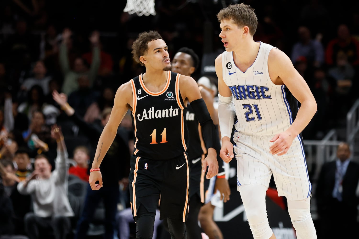 Hawks guard Trae Young chats with Magic center Moritz Wagner during the second half Monday night in Atlanta.(Miguel Martinez / miguel.martinezjimenez@ajc.com)