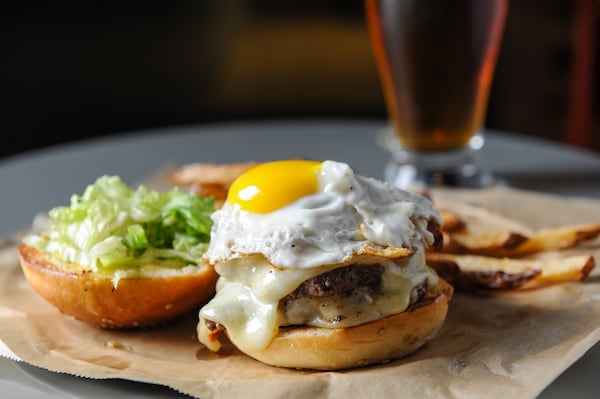 The Comet Burger has two 3-ounce patties, bacon, cheddar, a fried egg, beer dijonnaise and mixed greens. (BECKY STEIN PHOTOGRAPHY)