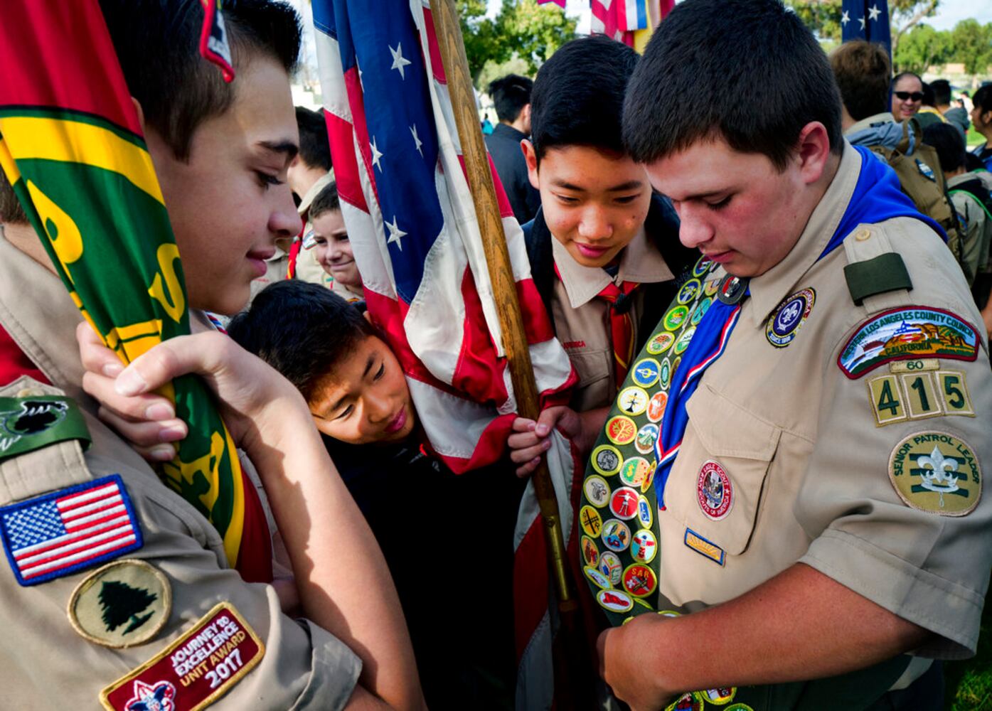 scouts place flags at veteran graves to honor memorial day