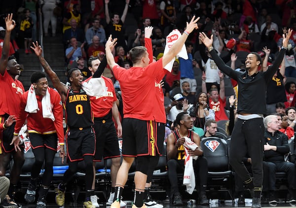 Hawks players celebrate at the end of the second half in the NBA play-in tournament April 13 at State Farm Arena. The Hawks defeated the Hornets 132-103. (Hyosub Shin / Hyosub.Shin@ajc.com)