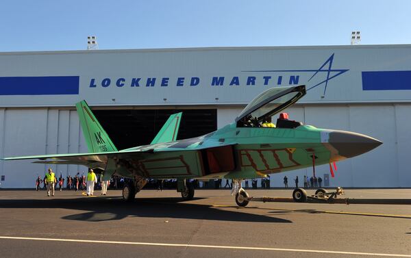 The final Lockheed Martin F-22 Raptor fighter jet is rolled off the assembly line in Marietta Tuesday December 13, 2011. The total cost of the F-22 program was about $62 billion for about 200 planes. (Brant Sanderlin/AJC)