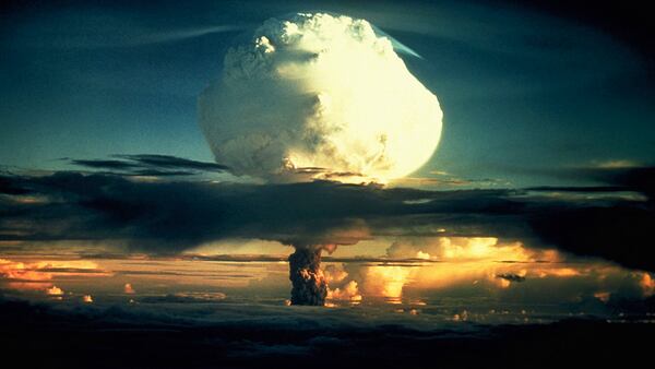 1952 photo of a billowing white mushroom cloud, mottled with orange, pushes through a layer of clouds during Operation Ivy, the first test of a hydrogen bomb, at Enewetak Atoll in the Marshall Islands. (Photo by Â© CORBIS/Corbis via Getty Images)