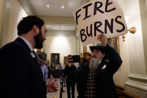 State Sen. Colton Moore, R-Trenton, greets supporter Maxwell Britton after the annual State of the Judiciary on Tuesday, January 28, 2025. He records him with his cellphone.
(Miguel Martinez/ AJC)