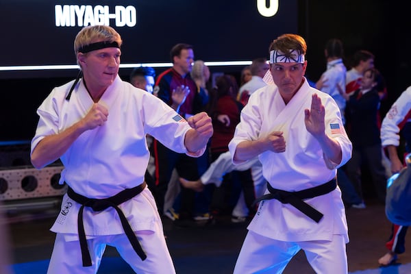 William Zabka (left) and Ralph Macchio show some moves in "Cobra Kai." Macchio will appear alongside Jackie Chan in "Karate Kid: Legends," a film due for release on May 30 that reportedly takes place three years after the events of "Cobra Kai."  Courtesy of Netflix