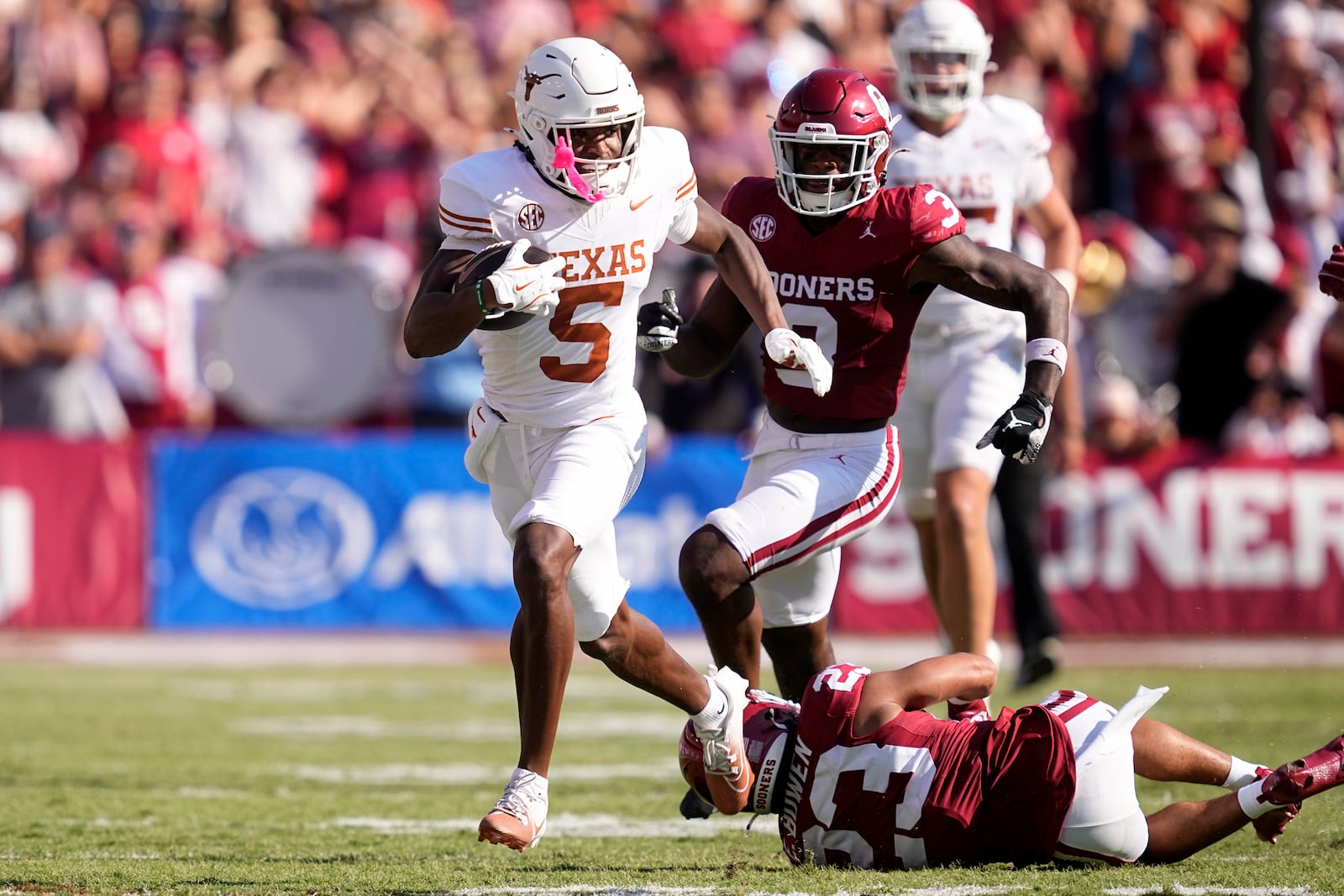 Texas wide receiver Ryan Wingo (5) escapes a tackle attempt by Oklahoma defensive back Eli Bowen (23) in the first half of an NCAA college football game in Dallas, Saturday, Oct. 12, 2024. (AP Photo/Tony Gutierrez)