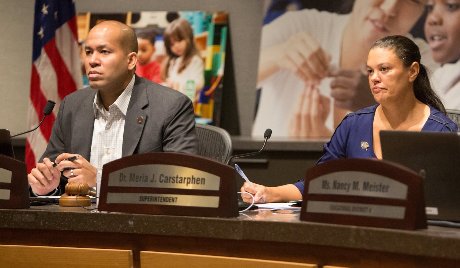 Atlanta school board chairman Jason Esteves (left) and Superintendent Meria Carstarphen listen to public comment during a special meeting to discuss whether to extend Carstarphen’s contract. (Photo by Phil Skinner).