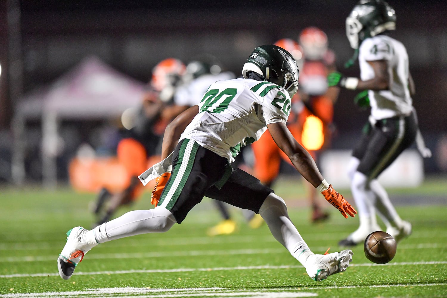 Collins Hill’s Cam Jones (20) scrambles to recover his fumbled ball after a kickoff in the first half of play Friday, Nov. 10, 2023 at North Cobb High School. (Daniel Varnado/For the AJC)