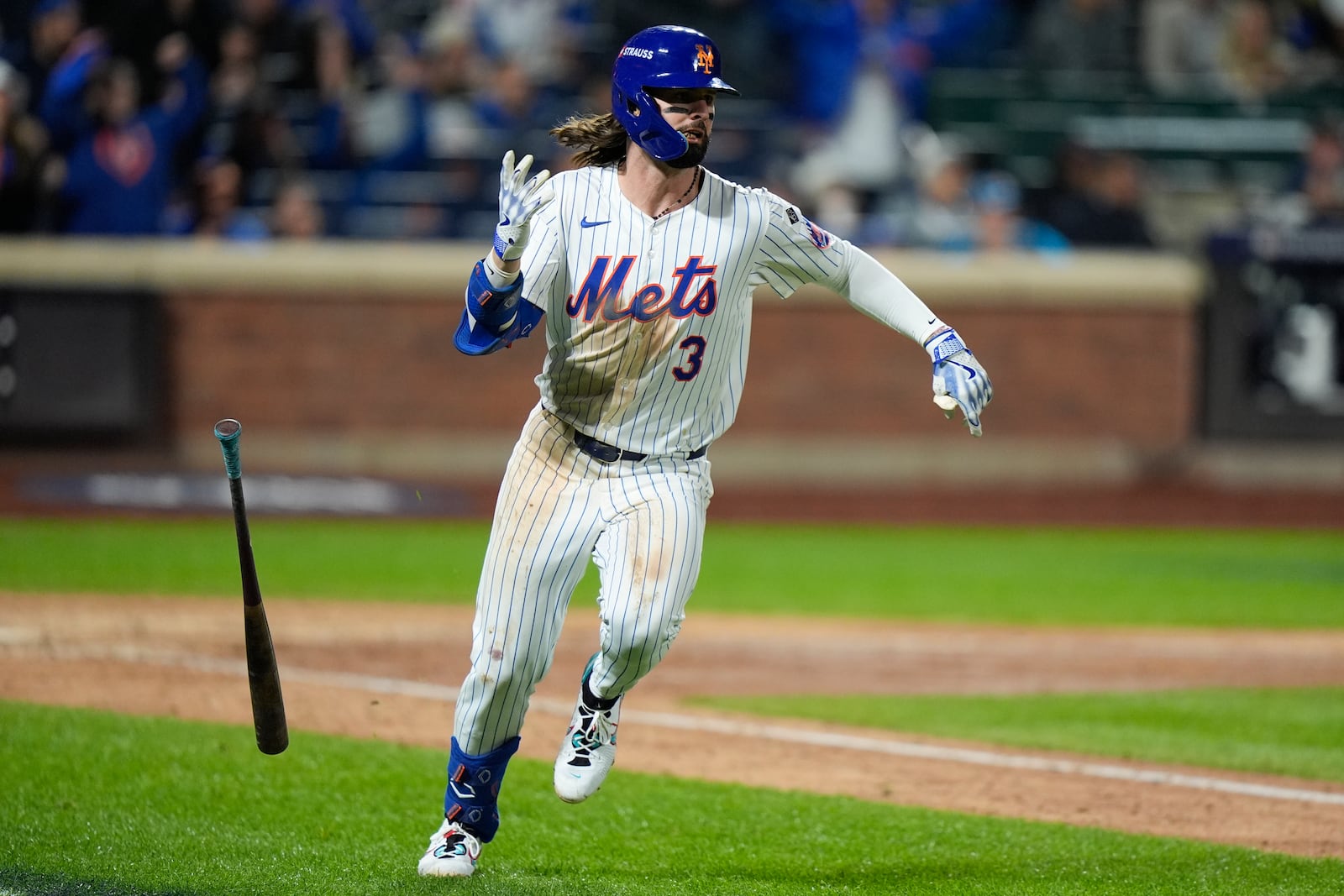 New York Mets' Jesse Winker watches his single against the Los Angeles Dodgers during the eighth inning in Game 5 of a baseball NL Championship Series, Friday, Oct. 18, 2024, in New York. (AP Photo/Frank Franklin II)