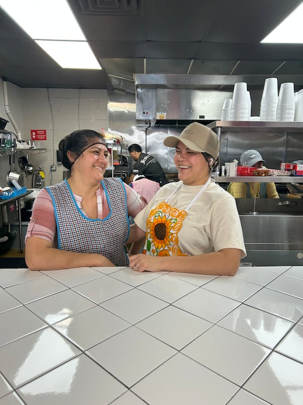 Veronica Martinez (left) laughs with her daughter Brenda Martinez at their Marietta restaurant Cocina de la Tia.