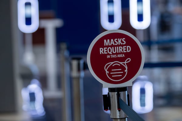 A sign requiring customers to wear masks is displayed at the Delta Air Lines ticket counter line at Hartsfield-Jackson Atlanta International Airport, Friday, September 4, 2020. (Alyssa Pointer / Alyssa.Pointer@ajc.com)