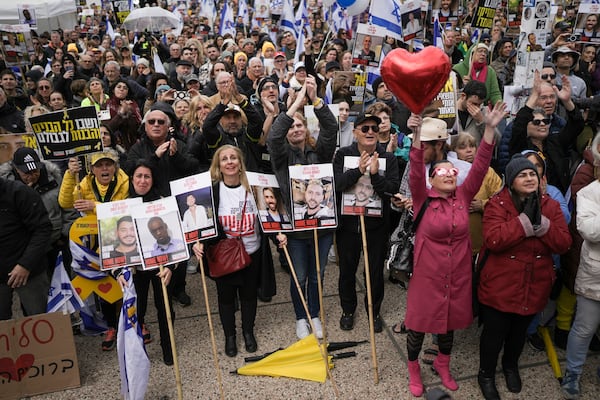 Israelis react as the first two of six hostages to be released in Gaza by Palestinian militants are handed over to the Red Cross as they watch a live broadcast in 'Hostages Square' in Tel Aviv, Israel, Saturday Feb. 22, 2025. (AP Photo/Oded Balilty)