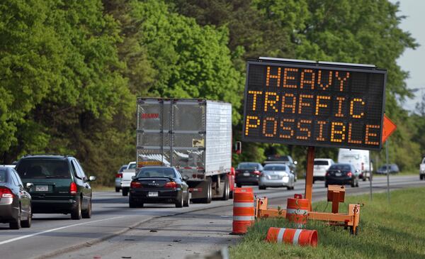 SECONDARY PHOTO: April 22, 2013 - Stockbridge, Ga: Rush hour traffic travel southbound on I-75 south past a sign reading, "Heavy traffic possible during spring break," as they approach the Jodeco Road exit Monday afternoon in Stockbridge, Ga., April 22, 2013. Georgia is about to construct its first new toll road since Ga. 400 and almost no one is talking about it. In Henry County and a small part of Clayton, I-75 will soon sprout additional lanes, to be tolled electronically, and the project goes out to bid in two months. JASON GETZ / JGETZ@AJC.COM