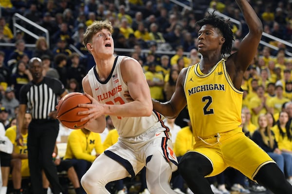 Illinois guard Kasparas Jakucionis, left, looks to shoot as he is defended by Michigan guard L.J. Cason (2) during the first half of an NCAA college basketball game, Sunday, March 2, 2025, in Ann Arbor, Mich. (AP Photo/Jose Juarez)