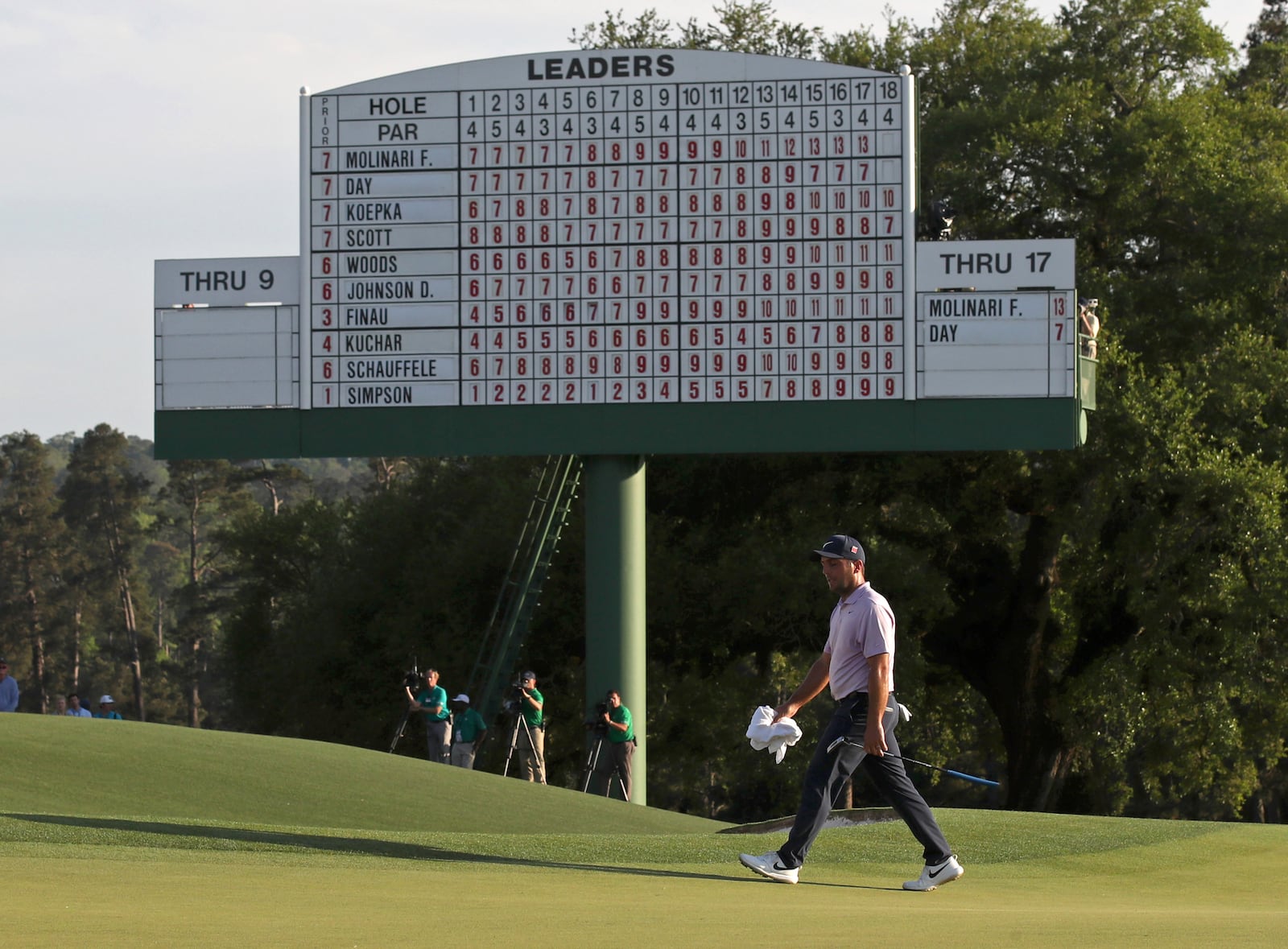 Francesco Molinari walks past the scoreboard on the 18th green before he finished the day at 13 under for the lead during the third round of the Masters Tournament Saturday, April 13, 2019, at Augusta National Golf Club in Augusta. (JASON GETZ/SPECIAL TO THE AJC)