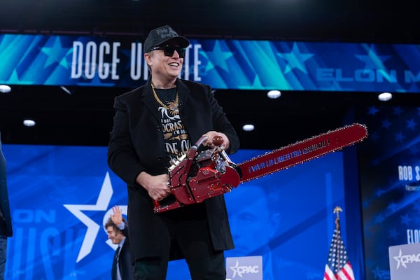 Elon Musk hold a chainsaw as he arrives to speak at the Conservative Political Action Conference, CPAC, at the Gaylord National Resort & Convention Center, Thursday, Feb. 20, 2025, in Oxon Hill, Md. (AP Photo/Jose Luis Magana)