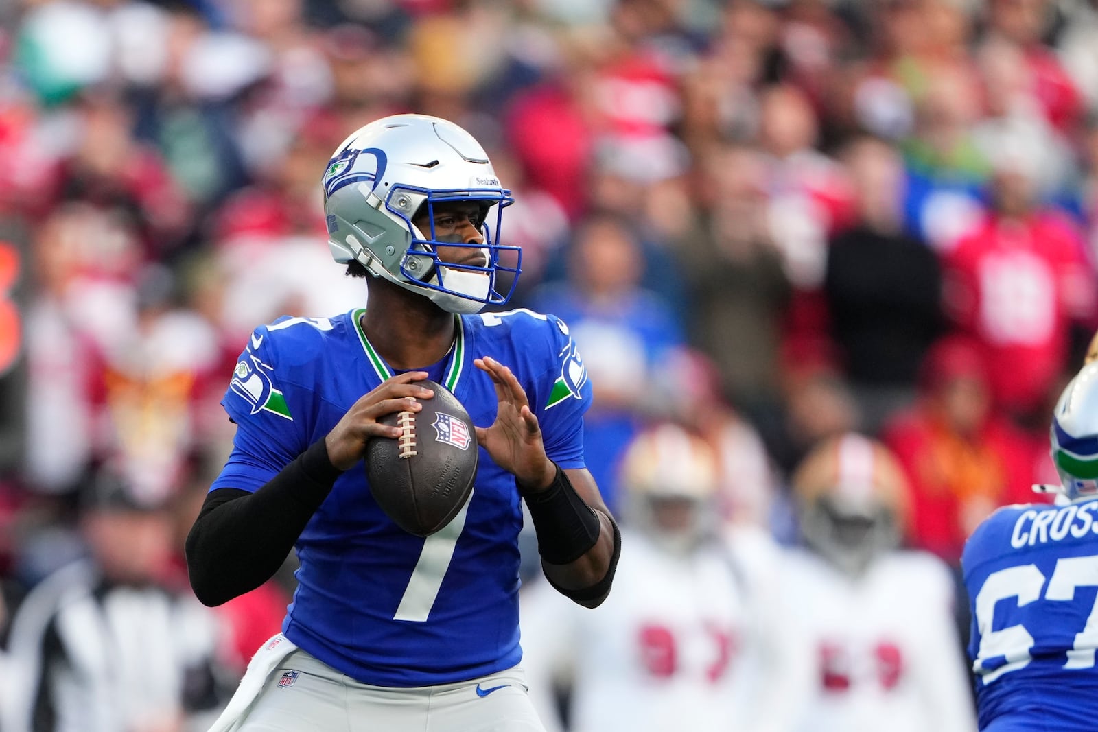 Seattle Seahawks quarterback Geno Smith looks to throws during the first half of an NFL football game against the San Francisco 49ers, Thursday, Oct. 10, 2024, in Seattle. (AP Photo/Lindsey Wasson)