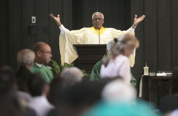 Sam Hagan was the cantor at St. Jude the Apostle Catholic Church in Sandy Springs for years. Here he sings as members take communion. (Photo by Phil Skinner)