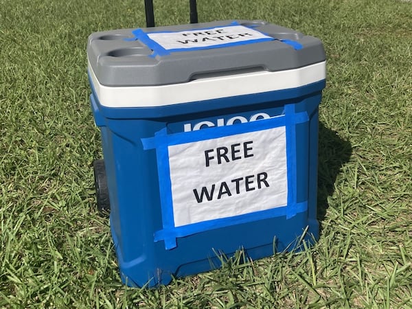 A cooler full of bottle water sits outside the Savannah Civic Center, an early voting location in Chatham County. (Adam Van Brimmer/adam.vanbrimmer@ajc.com)