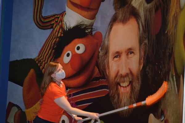 Jill Nash Malool, museum director at the Center for Puppetry Arts, helps sanitize exhibits at the museum, which opens to the public July 10. The center still won’t be bringing audiences into its theater, but it is livestreaming performances for an online audience. CONTRIBUTED: CENTER FOR PUPPETRY ARTS