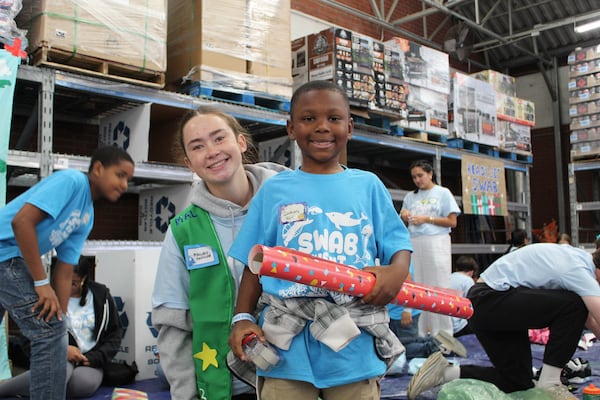 Zachary, 7, picked out his wrapping paper to wrap his gifts with his mentor Mallory Houlihan in Walmart on Nov. 10, 2024 in Athens, Georgia. (Photo Courtesy of Rachel Sandstrom)