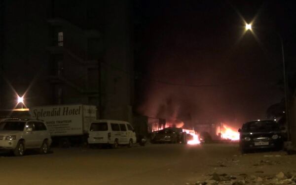 In this grab taken from video by Associated Press Television,  the scene of an attack on a hotel, in Ouagadougou, Burkina Faso, Friday, Jan. 15, 2016.  Attackers struck an upscale hotel popular with Westerners in Burkina Faso's capital late Friday, fueling the recent political turmoil in the West African country. Three hours later, gunfire could still be heard as soldiers in an armored vehicle finally approached the area. (AP Television) 