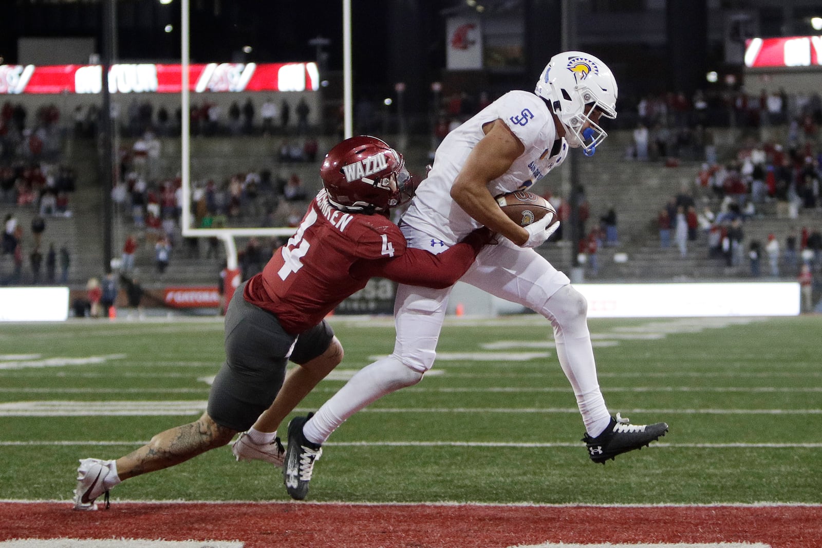 San Jose State wide receiver Nick Nash, right, scores a touchdown while pressured by Washington State defensive back Kapena Gushiken (4) during double overtime in an NCAA college football game, Friday, Sept. 20, 2024, in Pullman, Wash. (AP Photo/Young Kwak)