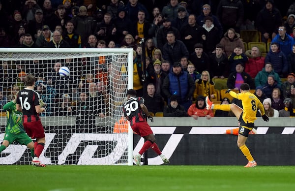 Wolverhampton Wanderers' Joao Gomes, right, scores their side's first goal of the game during the English Premier League soccer match between Wolverhampton Wanderers and Fulham at Molineux Stadium, Wolverhampton, England, Tuesday, Feb. 25, 2025. (Jacob King/PA via AP)